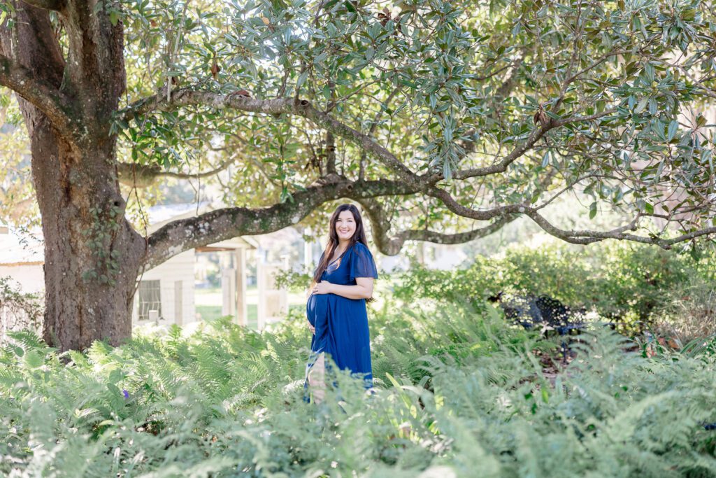 Tallahassee maternity photography - Maternity mom navy dress under arch of green tree